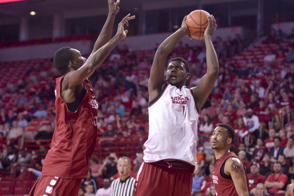 Trey Thompson (white) shoots as Willy Kouassi (red) defends on Sunday, Nov. 1, 2015, during the Arkansas men's basketball Red-White game in Bud Walton Arena in Fayetteville. 