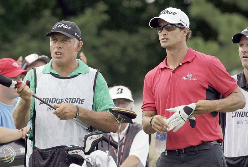 Adam Scott, front right, from Australia, and caddie Steve Williams stand on the 17th tee during first round play in the Bridgestone Invitational golf tournament at Firestone Country Club in Akron, Ohio, Thursday, Aug. 4, 2011. 