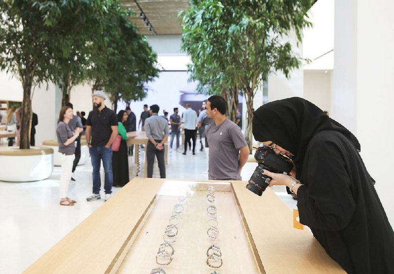 A photographer takes a photo of Apple watches at the Apple Store last week ahead of its grand opening in Dubai, United Arab Emirates.
