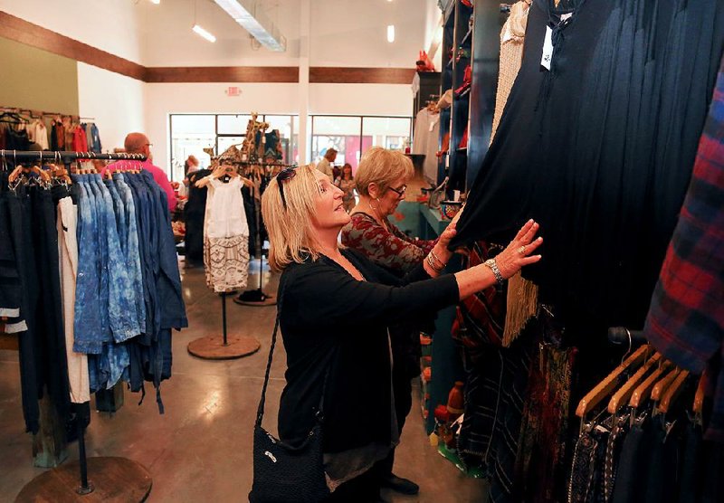 Uniq, a locally owned store at Outlets of Little Rock mall, lured in shoppers Mary Edwards (left, front) and Judy Archer, both of Clinton.