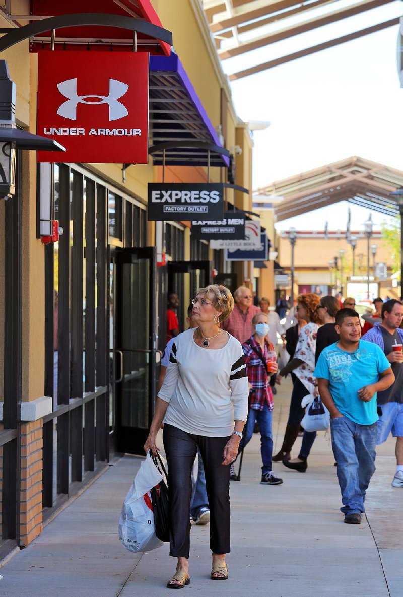 Arkansas Democrat-Gazette/JOHN SYKES JR. - Shoppers stroll along the store fronts of the Outlets of Little Rock outlet mall.
