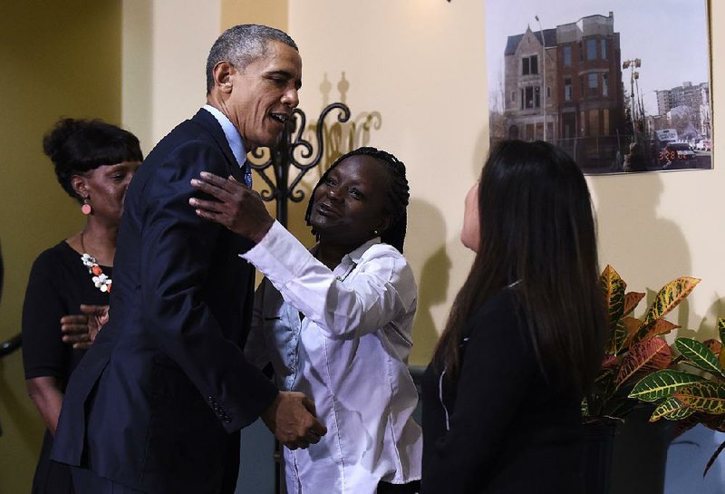 President Barack Obama hugs Stephanie Luna as Robin Shorter (left) and Sharon Boatwright watch Monday during Obama’s visit to Integrity House, a residential rehabilitation facility in Newark, N.J.
