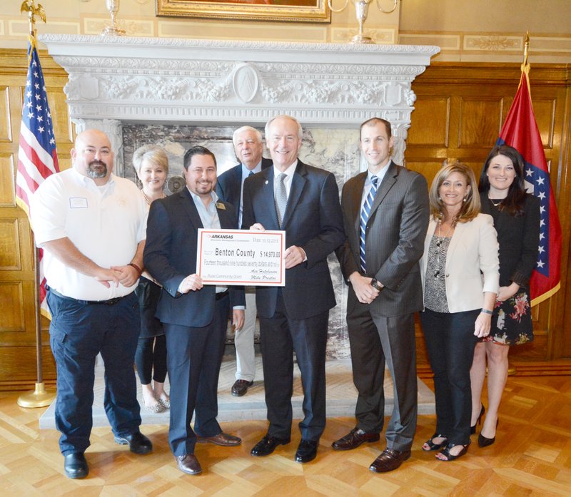 Photograph submitted Benton County fire marshal Marc Trollinger is shown with, from left: ARDC Commissioner Lynn Hawkins, Marshall Watson, ARDC Chair Glenn Priebe, Governor Asa Hutchinson, AEDC Director Mike Preston, AEDC Deputy Director Amy Fecher and DRS Director Alex Johnston. Not pictured are Arkansas Senator Cecile Bledsoe and Representative Grant Hodges.