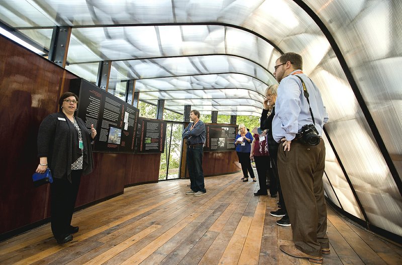 Niki Stewart, Director of Education and Exhibitions, talks to guests in the Welcome Pavilion on during a media preview of Frank Lloyd Wright's Bachman-Wilson House on Thursday, Oct. 8, 2015, on the grounds of Crystal Bridges Museum of American Art in Bentonville.