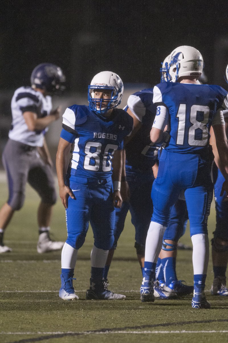 Armando Rodriguez, Rogers High tight end, looks to the Mounties sideline next to 6-foot-2 quarterback Andrew McGlynn during a recent game.