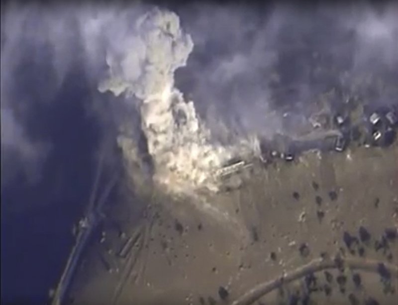 This photo made from the footage taken from Russian Defense Ministry official web site on Monday, Nov. 2, 2015 shows a target hit during a Russian air raid in Syria. Russian Defense Ministry said the strike was performed by an Su-34M bomber in Aleppo province.