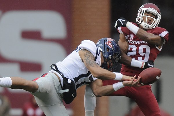 Arkansas cornerback Jared Collins deflects a pass intended for Ole Miss tight end Evan Engram during a game Saturday, Nov. 22, 2014, at Razorback Stadium in Fayetteville. 