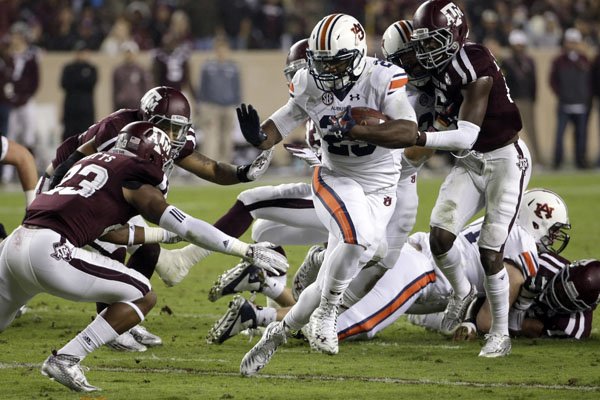 Auburn running back Jovon Robinson (29) breaks away from Texas A&M defensive back Armani Watts (23) during the first quarter of an NCAA college football game, Saturday, Nov. 7, 2015, in College Station, Texas. (AP Photo/David J. Phillip)