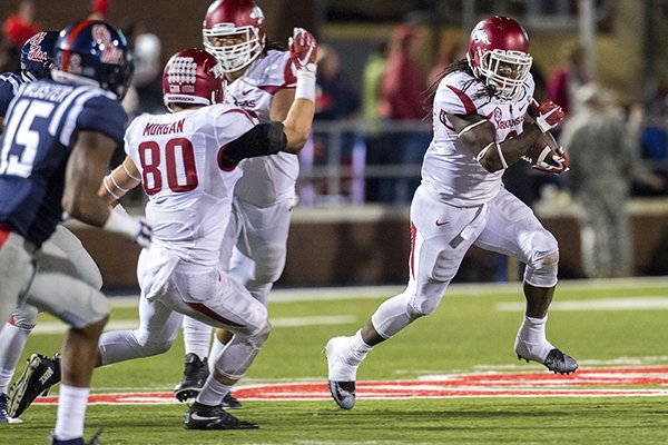 Arkansas running back Alex Collins carries the ball on a fourth-down play on Saturday, Nov. 7, 2015, during overtime against Ole Miss at Vaught-Hemingway Stadium in Oxford, Miss.
