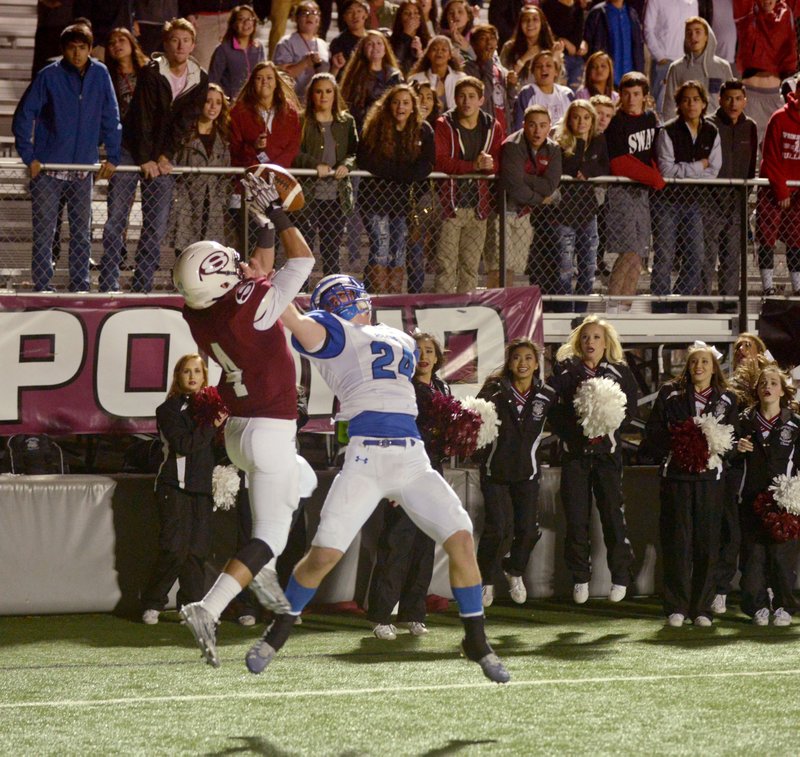 Hunter Necessary (4), Springdale High wide receiver, catches a 12-yard touchdown pass Friday over Jay Young, Rogers High cornerback, with 53 seconds left in the game at Jarrell Williams Bulldog Stadium in Springdale. Springdale won the game 25-22.