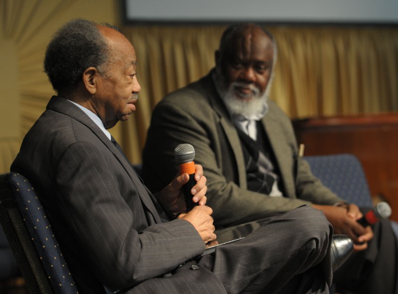 Gordon Morgan (left) and John Newman speak about their lives Saturday while participating in a program as a part of the “Let There Be Light, 100 Black Men” project by local photographer Andrew Kilgore at St. James Missionary Baptist Church in Fayetteville.