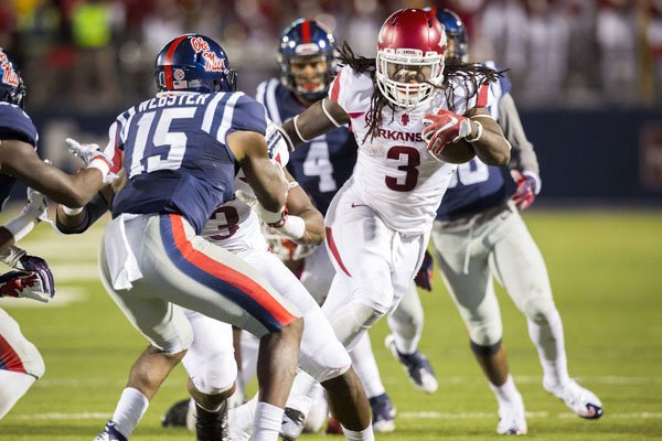 Arkansas running back Alex Collins carries the ball on a fourth-down play on Saturday, Nov. 7, 2015, during overtime against Ole Miss at Vaught-Hemingway Stadium in Oxford, Miss.