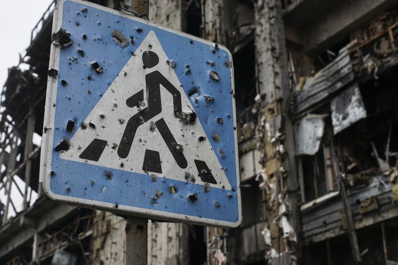 A road sign shredded by shrapnel still stands in front of the war-ravaged airport in Donetsk in eastern Ukraine.