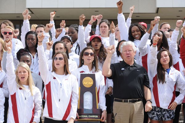 Lance Harter, head women's track and field coach at the University of Arkansas, leads a Hog call alongside members of his team during a pep rally Tuesday, March 17, 2015, to celebrate the team's national championship on the Arkansas Union Mall at the university campus in Fayetteville. The team won the school's first national championship in a women's sport and was cheered on by members of the school's spirit squads and pep band.