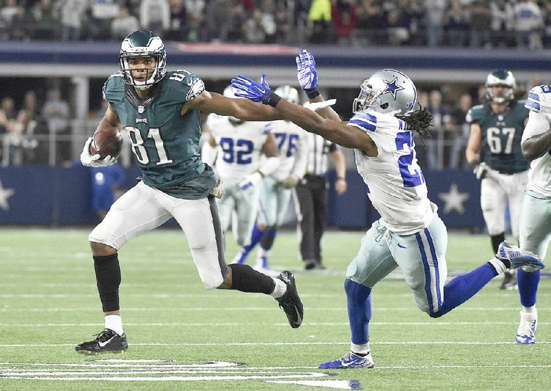 Philadelphia wide receiver Jordan Matthews (81) sheds a tackle from Dallas safety J.J. Wilcox and heads toward the end zone for the game-winning, 41-yard touchdown in overtime to give the Eagles a 33-27 victory Sunday at AT&T Stadium in Arlington, Texas.