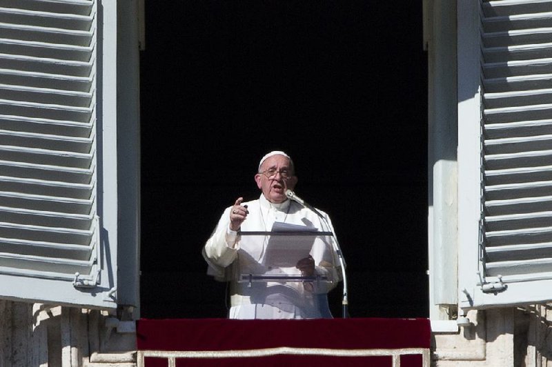 Pope Francis delivers his message during his Angelus prayer from his studio window overlooking St. Peter’s Square on Sunday at the Vatican.