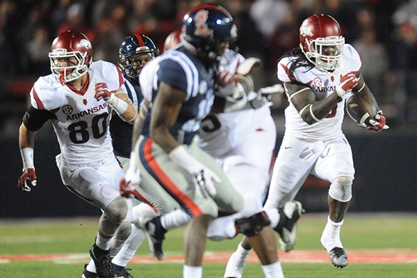 Arkansas running back Alex Collins (3) runs with a lateral from tight end Hunter Henry (84) to get a first down on a 4th and 25 play against Mississippi in Oxford, Miss., on Saturday, Nov. 7, 2015. Arkansas won 53-52 in overtime. (Bruce Newman /The Oxford Eagle via AP)