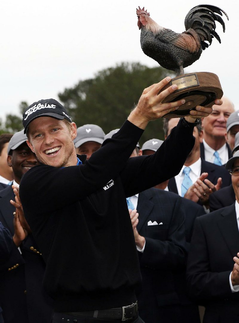 Peter Malnati shows off "Reveille," the trophy of the Sanderson Farms Championship after winning for the first time on the PGA Tour, closing with a 5-under 67 to win in Jackson, Miss., Monday, Nov. 9, 2015. Malnati finished at 18 under in for the tournament.