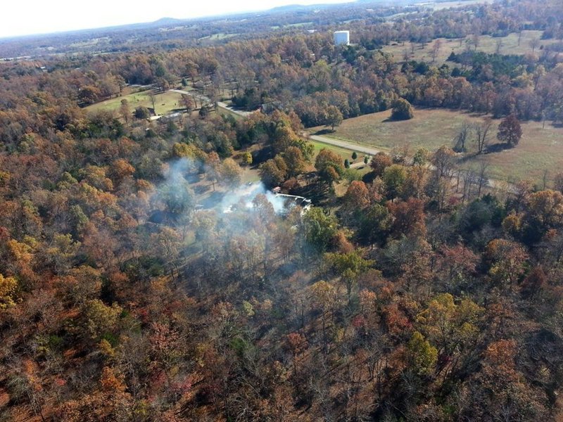 Smoke is seen billowing from a house at 447 Baxter County Road 508 on Saturday, Nov. 7, 2015.