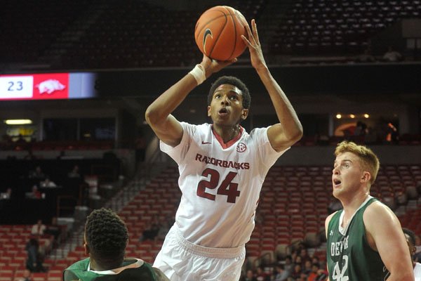 Arkansas guard Jimmy Whitt drives to the hoop past Delta State defenders Tuesday, Nov. 10, 2015, at Bud Walton Arena in Fayetteville.