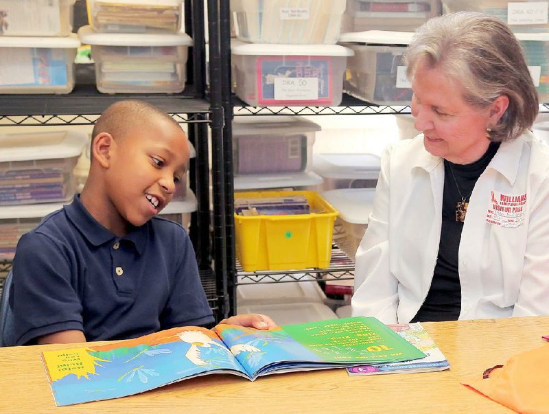 Mary Dee Taylor of Little Rock tutors Williams Traditional Magnet Elementary third-grade pupil Trenton Gaines, 8, as part of the AR Kids Read literacy initiative for central Arkansas students.