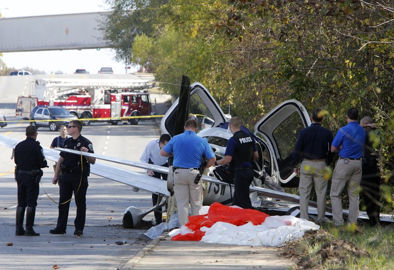 File Photo/NWA Democrat-Gazette/DAVID GOTTSCHALK Emergency responders secure the scene of a small airplane crash Nov. 3 on Martin Luther King Boulevard in Fayetteville.