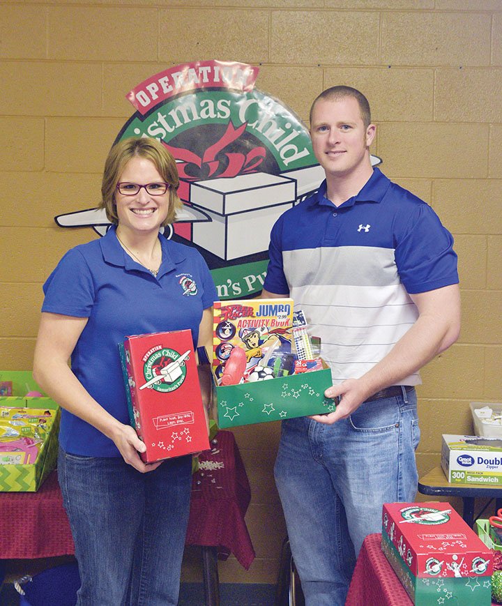 Erica Cason holds an Operation Christmas Child shoebox, and her husband, Andy, holds a box filled with items from the GO Store at The Ministry Center in Conway. The Casons buy items on sale or in bulk so people can buy the items inexpensively to fill shoeboxes for the Samaritan’s Purse program, in which filled shoeboxes are sent to more than 100 countries. Fellowship Bible Church, 1051 Hogan Lane in Conway, is the collection point this year for the boxes. The boxes will be collected from 10 a.m. to 2 p.m. Monday through Nov. 20, with evening hours Wednesday from 7-9; from 10 a.m. to 1 p.m. Nov. 21;  from 1-6 p.m. Nov. 22; and from 9 a.m. to noon Nov. 23.