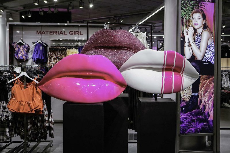 Giant lips greet shoppers at the Macy’s Inc. flagship store in New York in September. Third-quarter revenue for Macy’s fell to $5.87 billion, short of the $6.15 billion Wall Street had forecast. 
