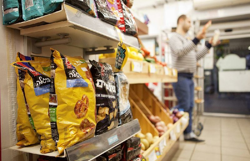 Food products made in a Jewish settlement in the West Bank are on display Wednesday at a supermarket in Tel Aviv. 