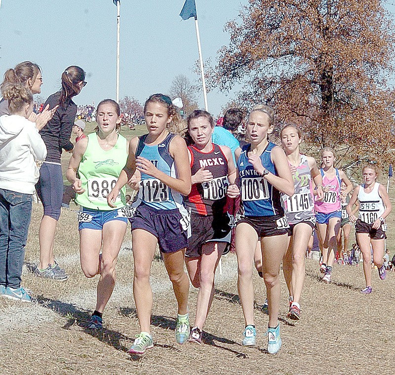 Photo by Rick Peck McDonald County&#x2019;s Emily High, third from left, battles with Cassandra Brown (989, Blue Springs South), Margaret Morse (1123, Parkaway West) and Mackenzie Miller (1001, St. Joseph Central) for position during the final stretch of Saturday&#x2019;s Class 4 cross country championships in Jefferson City.