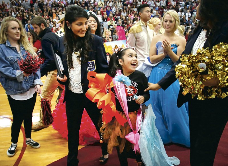 Andrea "Isa" Perez, a first grade student from Tyson Elementary School, is Friday, November 6, 2015, surprised when she receives a trip to Disney World during a special event pep rally at Springdale High School. Isa received the trip through the Make A Wish Foundation Mid-South Chapter with funds raised by the student organization DECA at the High School.
