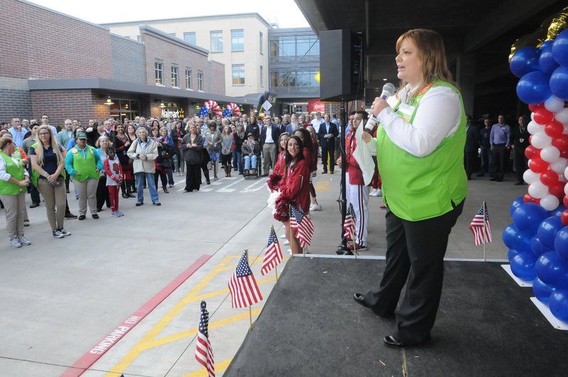 Jessica Kirk, manager of the Walmart Neighborhood Market in downtown Bentonville, talks about the store Wednesday during opening festivities.