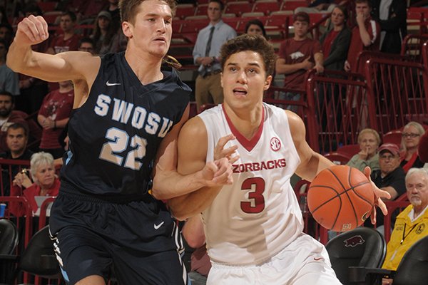 Dusty Hannahs (3) of Arkansas drives past Collin Jennings (22) of Southwestern Oklahoma State Thursday, Nov. 5, 2015, during the first half in Bud Walton Arena. 