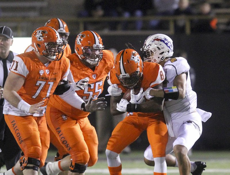 Bowling Green’s Travis Greene (8) tries to escape a tackle in the first half of a 41-27 victory over Western Michigan on Wednesday. Greene rushed for 170 yards and scored three times. 