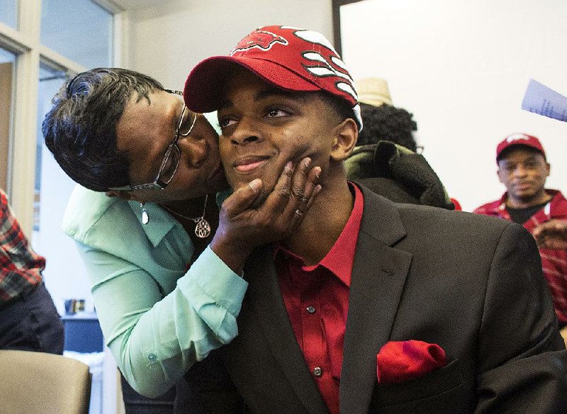 Arkansas Democrat-Gazette/MELISSA SUE GERRITS - 11/12/15 - Janice Birt kisses her nephew Daryl Macon after he signed with the Arkansas Razorbacks' Basketball team November 12, 2015 at the Little Rock Chamber of Commerce. Macon was joined by his mom Deloise, sisters Tiffany and Tierra as well as extended family members, coaches and friends to celebrate his signing. 