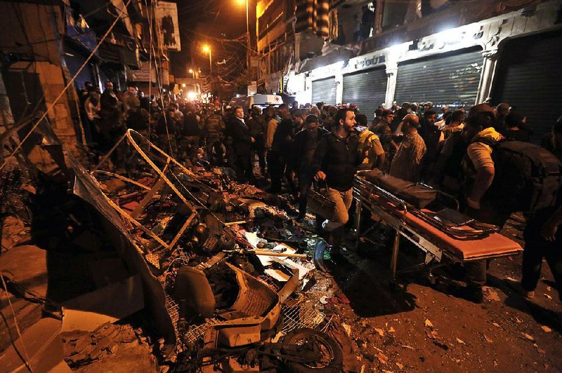 Lebanese soldiers and civilians rush to help after suicide bombings Thursday in the Beiruit suburb of Burj al-Barajneh. 