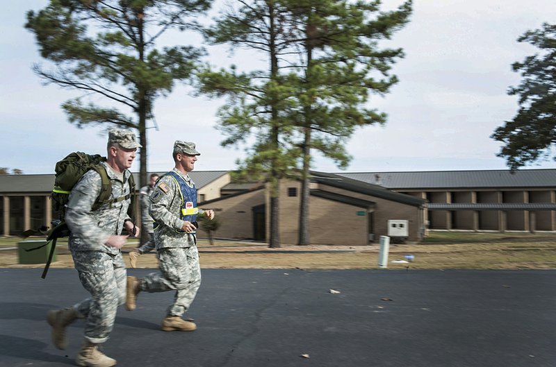U.S. Army Col. Douglas Rose, left, runs alongside U.S. Army Command Sgt. Maj. Gregory Slater to the finish line of the Norwegian Foot March on Oct. 30 at Camp Robinson in Little Rock. Slater finished first with a time of 3 hours, 26 minutes.