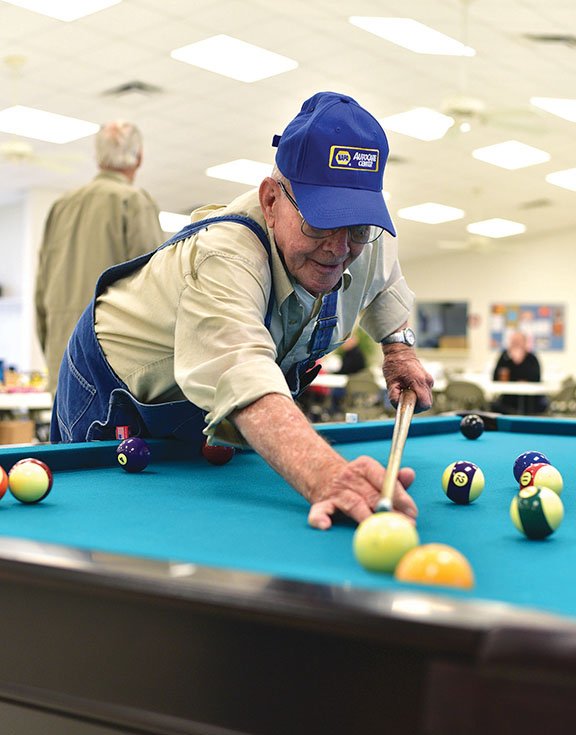 Winston Tucker of Shirley shoots pool last week at the Clinton Senior Center. Tucker, 80, said he has been playing since he was about 7 years old because his father owned a pool hall in Shirley. Tucker, a retired truck driver, said he plays almost every day. The Clinton Senior Center has a new pool table, which the players said makes playing more fun.