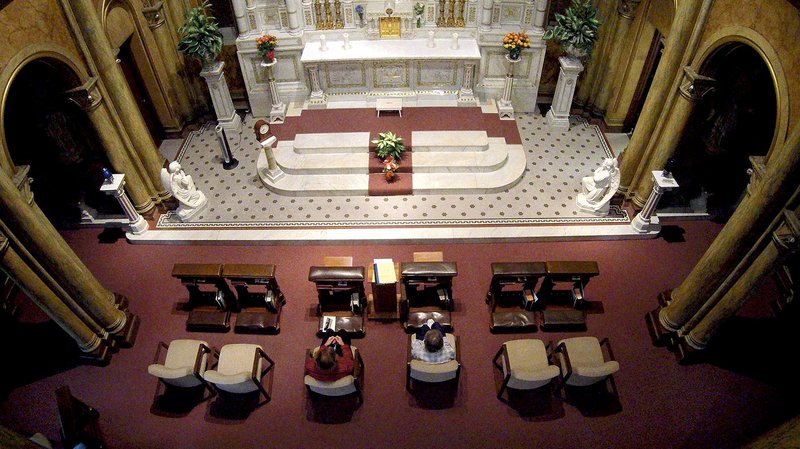 Donna Benden (left) and Sister Juanita Hytry pray at the Adoration Chapel in La Crosse, Wis. The Franciscan Sisters of Perpetual Adoration say they have been praying nonstop for 137 years. 