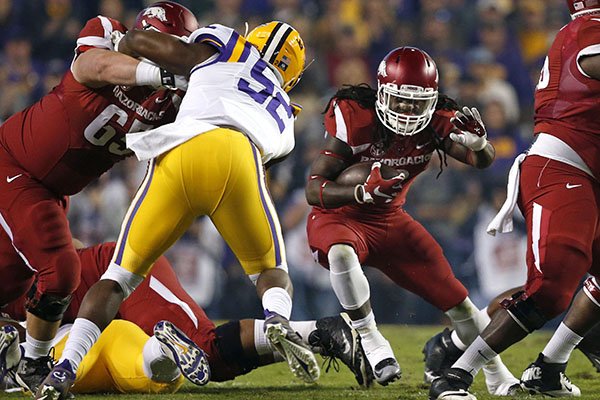 Arkansas running back Alex Collins (3) carries in the first half of an NCAA college football game against LSU in Baton Rouge, La., Saturday, Nov. 14, 2015. (AP Photo/Gerald Herbert)