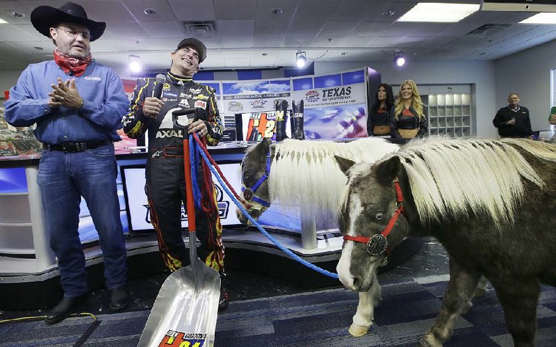 Four-time NASCAR champion Jeff Gordon is presented with a gift of two ponies from Texas Motor Speedway president Eddie Gossage on Nov. 6. In his final season, Gordon has received several gifts, including a trophy from Kentucky Speedway, a track where he never won, from members of the NASCAR media.