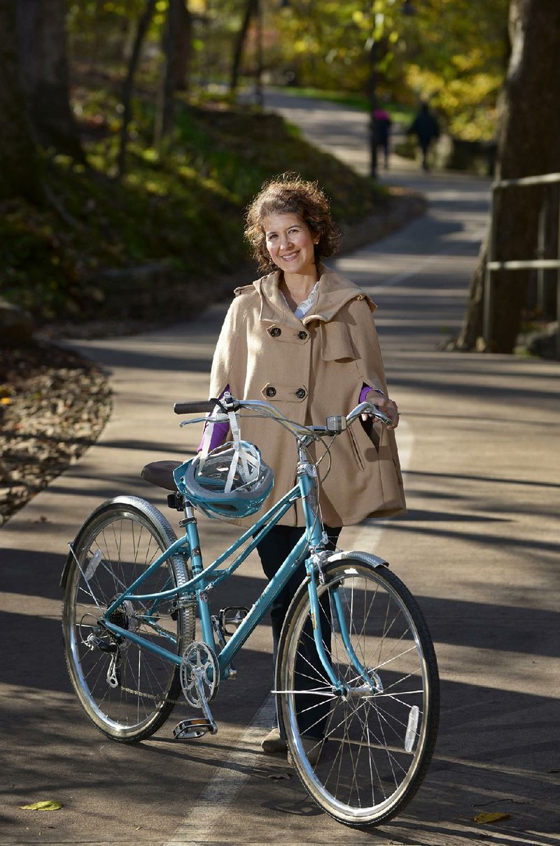 Karen Minkel, home region program director for the Walton Family Foundation, poses for a photo Thursday on the Razorback Regional Greenway trail near Compton Gardens and Conference Center in Bentonville. For more photos, go to www.nwadg.com/photos.