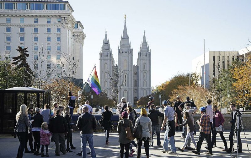 People in Salt Lake City walk past the Salt Lake Temple on Saturday after mailing letters, in which they resigned from The Church of Jesus Christ of Latter-day Saints.