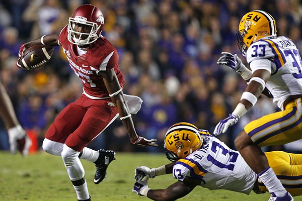 Arkansas wide receiver Dominique Reed (87) breaks free from LSU defensive back Dwayne Thomas (13) on a touchdown reception in the first half of an NCAA college football game in Baton Rouge, La., Saturday, Nov. 14, 2015. (AP Photo/Gerald Herbert)