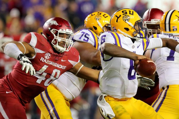 Arkansas' Deatrich Wise Jr., left, moves in to pressure LSU quarterback Brandon Harris, leading to an incomplete pass in the fourth quarter Saturday, Nov. 14, 2015, in Baton Rouge, La.