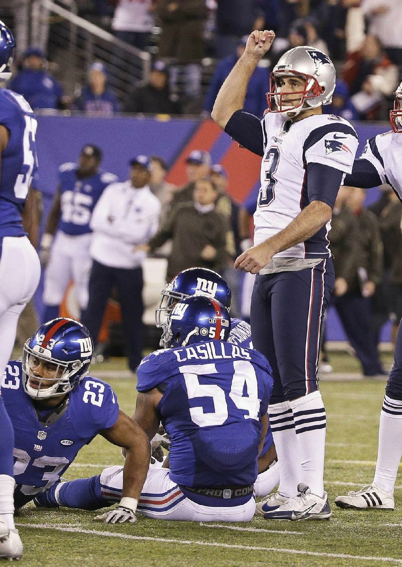 New England Patriots kicker Stephen Gostkowski (3) watches his 54-yard kick clear the goalpost for the game-winning field goal. New York Giants players Rashad Jennings (23) and Jonathan Casillas (54) attempted to block the kick in the final seconds of Sunday’s game in East Rutherford, N.J. The Patriots won 27-26.