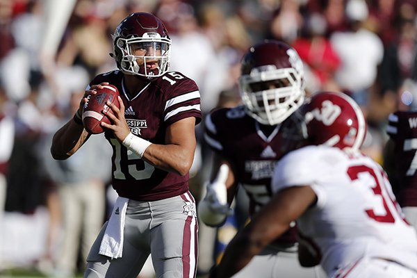 Mississippi State quarterback Dak Prescott (15) looks for an open receiver as he is pressured by Alabama linebacker Denzel Devall (30) during the first half of an NCAA college football game in Starkville, Miss., Saturday, Nov. 14, 2015. (AP Photo/Rogelio V. Solis)
