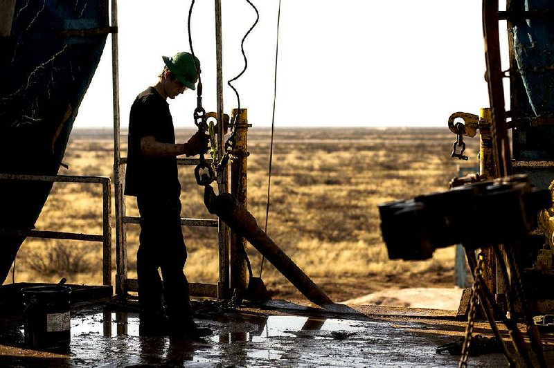 A worker prepares to connect a drill bit on Endeavor Energy Resources LP’s Big Dog Drilling Rig 22 in the Permian Basin outside Midland, Texas, in this file photo.