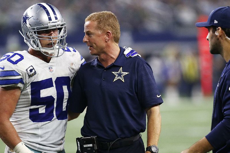 Dallas Cowboys Coach Jason Garrett talks with linebacker Sean Lee after a 33-27 loss to Philadelphia on Nov. 8. While Garrett liked his team’s effort in a 10-6 loss at Tampa Bay on Sunday, a columnist declared the Cowboys season over and said the Cowboys remain focused too much on outside distractions.