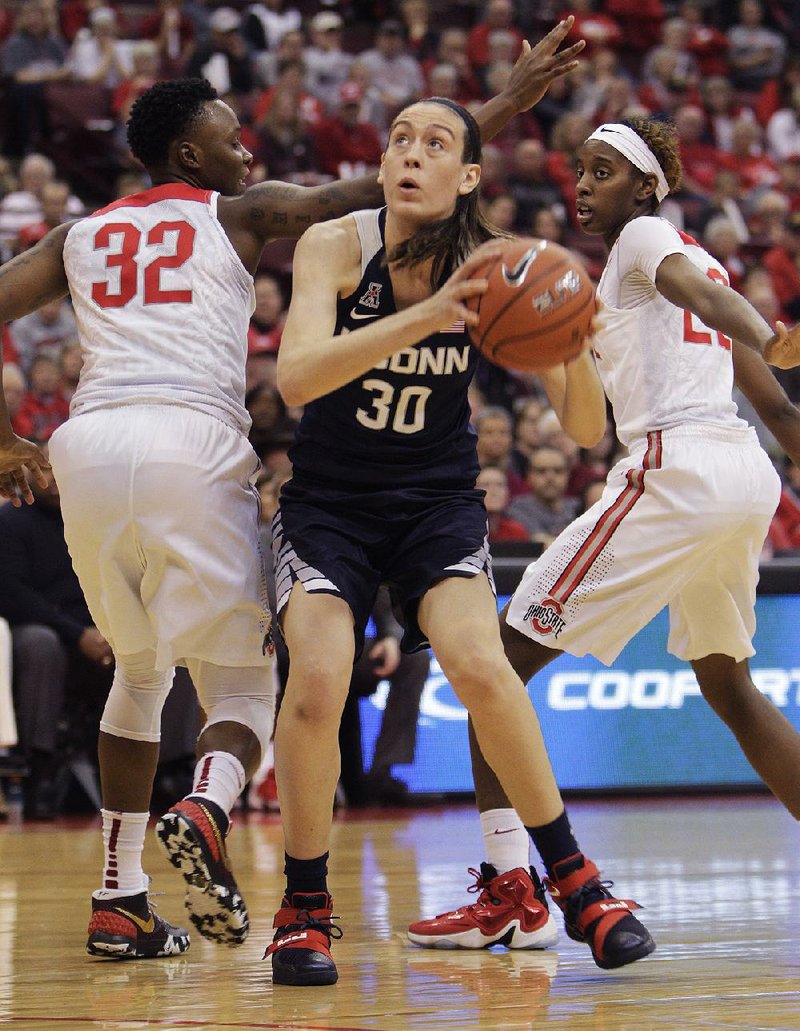 Connecticut forward Breanna Stewart (30) drives past Ohio State defenders Shayla Cooper (32) and Alexa Hart during Monday’s game. Stewart had 24 points and nine rebounds to lead the top-ranked Lady Huskies to a season-opening 100-56 victory.